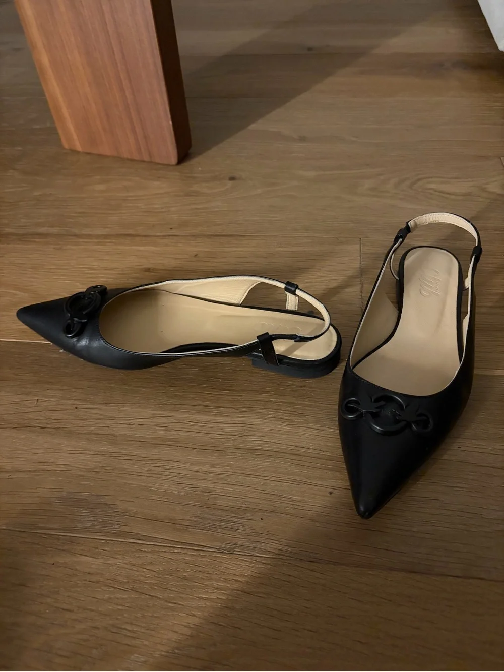 Black Pointed Slingback Flats with Decorative Logo Accent
